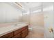 Bright bathroom with a large mirror, tile flooring, and a shower-tub combo at 5322 Shetland Ct, Highlands Ranch, CO 80130
