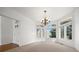 Bright dining room with bay windows, a chandelier, and neutral carpet at 5322 Shetland Ct, Highlands Ranch, CO 80130