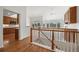 Open-concept entryway highlighting hardwood floors, staircase, and views into the kitchen and living area at 5322 Shetland Ct, Highlands Ranch, CO 80130