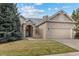 Charming brick home with a well-maintained lawn and attached two-car garage on a sunny day at 5322 Shetland Ct, Highlands Ranch, CO 80130