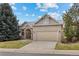 Inviting brick home with a two-car garage, arched entrance, and green lawn at 5322 Shetland Ct, Highlands Ranch, CO 80130
