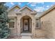 Inviting front porch with brick archway, decorative windows, and stylish front door at 5322 Shetland Ct, Highlands Ranch, CO 80130