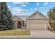 Charming single-Gathering home featuring a brick facade, arched entryway, and well-manicured lawn at 5322 Shetland Ct, Highlands Ranch, CO 80130