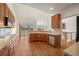 Spacious kitchen with wood floors, stainless steel appliances, and a view of the adjacent living room at 5322 Shetland Ct, Highlands Ranch, CO 80130