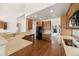 Open kitchen features wood floors, cabinets and countertops, and view of dining and living rooms at 5322 Shetland Ct, Highlands Ranch, CO 80130