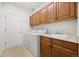 Functional laundry room with washer, dryer, sink and storage cabinets at 5322 Shetland Ct, Highlands Ranch, CO 80130