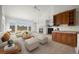 Bright living room featuring vaulted ceilings, a fireplace, built-in shelving, and a convenient wet bar at 5322 Shetland Ct, Highlands Ranch, CO 80130