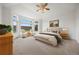 Spacious main bedroom with seating area, picture window, and plush carpeting at 5322 Shetland Ct, Highlands Ranch, CO 80130
