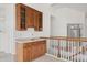 Wet bar area with wooden cabinetry, tiled countertops, and a sink, conveniently located near the staircase at 5322 Shetland Ct, Highlands Ranch, CO 80130