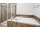 Bathroom features a bathtub, shower, and tile surround at 11932 W Long Cir # 201, Littleton, CO 80127