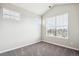 Well-lit bedroom with large windows and carpet flooring at 11932 W Long Cir # 201, Littleton, CO 80127