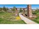 Landscaped walkway with a stone archway, leading through the community at 11932 W Long Cir # 201, Littleton, CO 80127