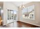 Dining room features hardwood floors and sliding glass doors to a covered patio at 11932 W Long Cir # 201, Littleton, CO 80127