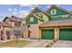 Beautiful two-story home with green and tan exterior, two-car garage, and landscaping at 11932 W Long Cir # 201, Littleton, CO 80127