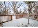 Backyard with wooden deck and snowy ground at 1876 S Chester Cir, Denver, CO 80247