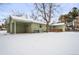 House exterior, detached garage and snowy backyard at 1876 S Chester Cir, Denver, CO 80247