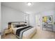 Bright bedroom with a queen bed and an attached bathroom at 1876 S Chester Cir, Denver, CO 80247