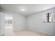 Well-lit bedroom with an exterior view and access to another room at 1876 S Chester Cir, Denver, CO 80247