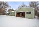 Detached garage with open door and snowy backyard at 1876 S Chester Cir, Denver, CO 80247