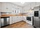 White kitchen cabinets, stainless steel appliances at 1876 S Chester Cir, Denver, CO 80247