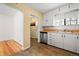 Kitchen with white cabinets and wood flooring at 1876 S Chester Cir, Denver, CO 80247