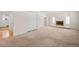 Living room with fireplace and carpet flooring, view of another room at 1876 S Chester Cir, Denver, CO 80247