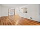 Bright living room with hardwood floors and view into kitchen at 1876 S Chester Cir, Denver, CO 80247