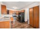 Kitchen with wood cabinets, stainless steel appliances, and laminate floor at 300 S Clinton St # 10C, Denver, CO 80247