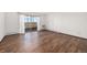 Bright living room with laminate flooring and sliding door to balcony at 300 S Clinton St # 10C, Denver, CO 80247