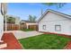 View of backyard showing grass area, privacy fence, and detached two-car garage at 2767 W 38Th Ave, Denver, CO 80211
