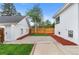View of the backyard showcasing a detached garage, paved patio, and fenced yard at 2767 W 38Th Ave, Denver, CO 80211