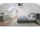 Spacious bedroom features skylight, ceiling fan, and hardwood floors at 2767 W 38Th Ave, Denver, CO 80211