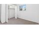 A bedroom features neutral carpet, a closet, and natural light from a window at 2767 W 38Th Ave, Denver, CO 80211