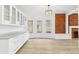 Bright dining room with custom cabinets, bay windows, and brick accent wall at 2767 W 38Th Ave, Denver, CO 80211