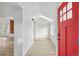 Inviting home foyer with a bright red door and beautiful hardwood floors at 2767 W 38Th Ave, Denver, CO 80211