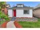 Charming single-Gathering home boasting a bright red door, river rock landscaping, and manicured lawn at 2767 W 38Th Ave, Denver, CO 80211