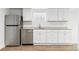 Bright kitchen features stainless steel appliances and white cabinets with a decorative glass block window at 2767 W 38Th Ave, Denver, CO 80211