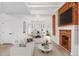 Open-concept living room and dining area featuring a brick fireplace and ample seating at 2767 W 38Th Ave, Denver, CO 80211