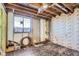 Unfinished basement room with window and exposed beams at 5421 S Sherman St, Littleton, CO 80121