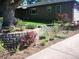 Landscaped front yard with retaining wall and mature trees at 5421 S Sherman St, Littleton, CO 80121