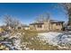 Tan house exterior with stone fireplace and snowy yard at 5421 S Sherman St, Littleton, CO 80121