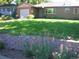 House exterior with green lawn and retaining wall at 5421 S Sherman St, Littleton, CO 80121