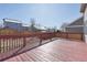 Spacious wood back deck with railings, perfect for outdoor enjoyment and entertainment with views of neighboring houses at 19844 E Vassar Ave, Aurora, CO 80013