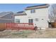 Exterior back of house showing a deck, sliding glass doors, and solar panels on the roof at 19844 E Vassar Ave, Aurora, CO 80013