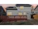 Exterior back of house showing a deck, sliding glass doors, and solar panels on the roof at sunset at 19844 E Vassar Ave, Aurora, CO 80013