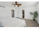 View of bright carpeted bedroom with two doorways and a tropical palm plant at 19844 E Vassar Ave, Aurora, CO 80013