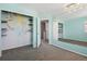 Bright bedroom with carpet, light blue walls, large mirror, and a closet with an open door and custom storage at 19844 E Vassar Ave, Aurora, CO 80013