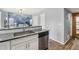 Modern kitchen with stainless steel appliances, gray countertops and backsplash, and white cabinets at 19844 E Vassar Ave, Aurora, CO 80013