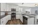 Updated kitchen featuring gray countertops, stainless steel appliances, and white cabinetry at 19844 E Vassar Ave, Aurora, CO 80013