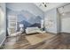 Bright living room with neutral decor, wood floors, and a mountain mural on the accent wall at 19844 E Vassar Ave, Aurora, CO 80013